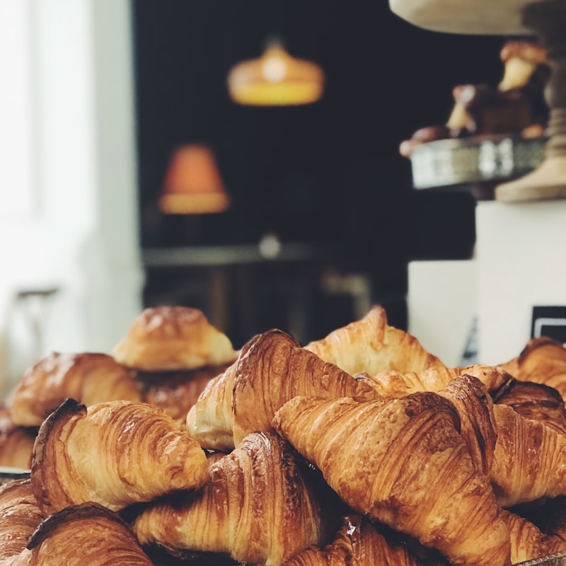 An almond croissant topped with flaked almonds and icing sugar