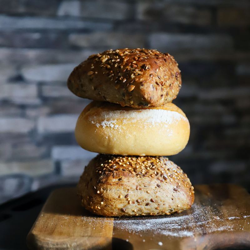 Assorted crusty bakery rolls topped with seeds and poppy